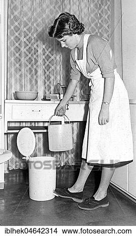 Picture - Housewife with trash can, 1960s, Germany, Europe. Fotosearch