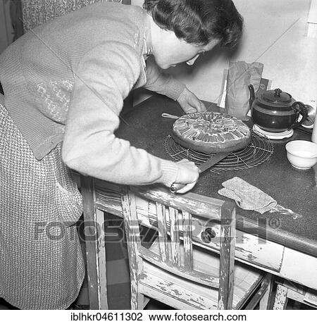 Stock Image - Housework, Woman baking cakes, ca. 1950, Freiburg, Germany, Europe. Fotosearch