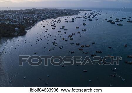Hundreds of fishing boats return to the beach at dawn, aerial view, sea at Mui Ne, Vietnam, Asia View Large Photo Image Stock Photograph - Hundreds of fishing boats return to the beach at dawn, aerial view, sea at Mui Ne, Vietnam, Asia. Fotosearch