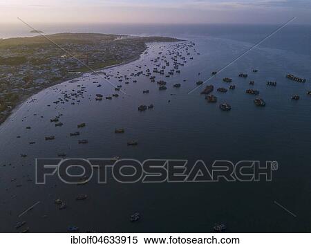 Hundreds of fishing boats return to the beach at dawn, aerial view, sea at Mui Ne, Vietnam, Asia View Large Photo Image Stock Photography - Hundreds of fishing boats return to the beach at dawn, aerial view, sea at Mui Ne, Vietnam, Asia. Fotosearch