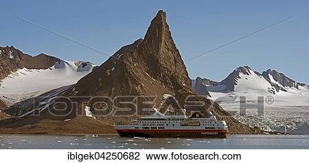 Hurtigruten ship in Hornsund, Butane mountain behind, 487 m, Ohomjakovbreen glacier on the right, Spitsbergen, Arctic, Norway, Europe View Large Photo Image Stock Image - Hurtigruten ship in Hornsund, Butane mountain behind, 487 m, Ohomjakovbreen glacier on the right, Spitsbergen, Arctic, Norway, Europe. Fotosearch