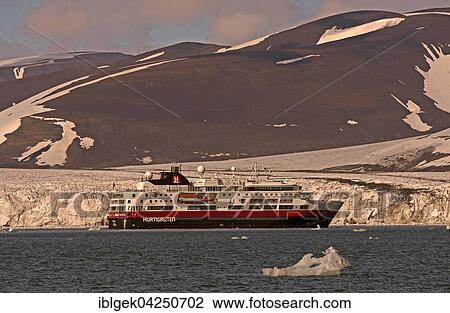 Stock Image - Hurtigruten ship in Hornsund, Storbreen glacier behind, Spitsbergen, Arctic, Norway, Europe. Fotosearch