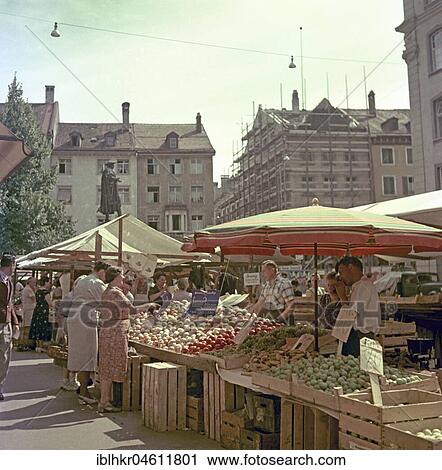 Stock Image - Hustle and bustle on a marketplace, Freiburger Münstermarkt, around 1950, near Freiburg, Germany, Europe. Fotosearch