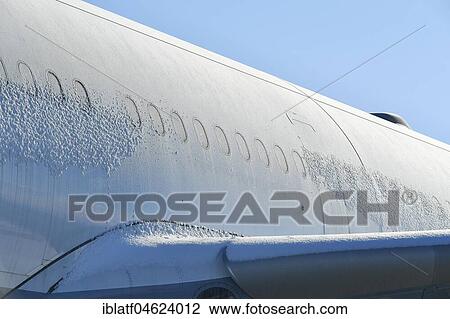 Stock Image - Ice-covered aircraft, windows, cabin, fuselage, wing iced, Lufthansa Airbus A 340-600, Munich Airport, Upper Bavaria, Germany, Europe. Fotosearch