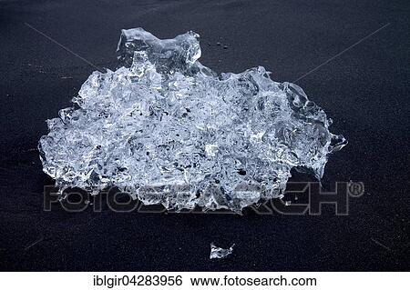 Stock Photograph - Ice crystal on black lava, Iceland, Europe. Fotosearch