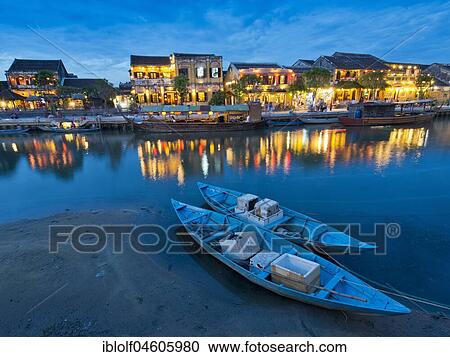 Illuminated old town at dusk, two boats in front on the river Thu Bon, Hoi An, Vietnam, Asia View Large Photo Image Stock Image - Illuminated old town at dusk, two boats in front on the river Thu Bon, Hoi An, Vietnam, Asia. Fotosearch