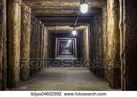 Stock Image - Illuminated underground tunnel in old, salt mine in Bochnia, Poland, Europe. Fotosearch