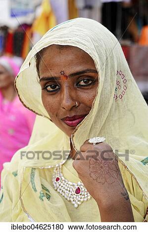 Indian woman with yellow scarf, portrait, Pushkar, Rajasthan, Northern India View Large Photo Image Stock Image - Indian woman with yellow scarf, portrait, Pushkar, Rajasthan, Northern India. Fotosearch