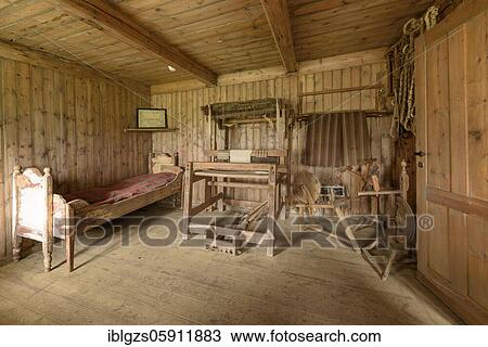 Stock Image - Interior view of a historic bedroom with bed and checked ceiling, loom and spinning wheel on a peat yard, sod house settlement Grenjadarstadur, Grenjaðarstaður, Þingeyjarsveit, Norðurland eystra, Iceland, Europe. Fotosearch