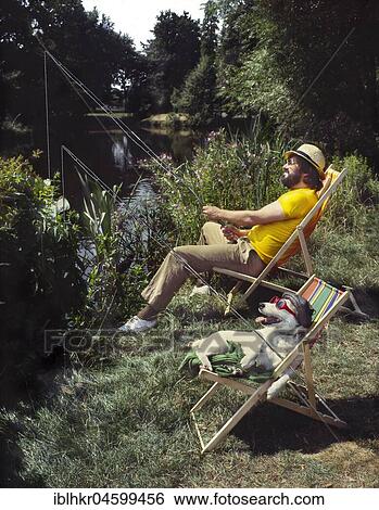 Stock Photograph - Jack Russell relaxes on the deck chair, England, Great Britain. Fotosearch