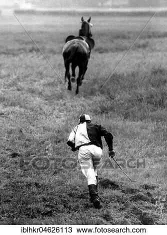 Stock Image - Jockey runs after his horse about 1970's, exact place unknown, Czech Republic, Europe. Fotosearch