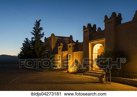 Stock Image - Kasbah style hotel at twilight, blue hour, Boumalne-du-Dades, Dades Valley, Morocco, Africa. Fotosearch
