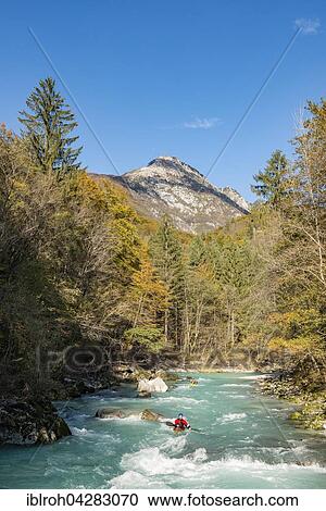 Stock Image - Kayakers on River Soca in autumn, Soca Valley, Triglav National Park, Slovenia, Europe. Fotosearch