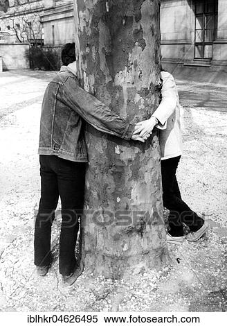 Stock Photography - Kissing behind a tree, ca. 1980s, East Berlin, GDR, Germany, Europe. Fotosearch