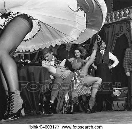 Stock Photo - Kissing couple behind blowing dance skirt, England, Great Britain. Fotosearch