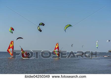 Stock Photo - Kitesurfers and windsurfers, Pringle Kitesurf World Cup, Sankt Peter-Ording, North Sea, North Frisia, Schleswig-Holstein, Germany, Europe. Fotosearch
