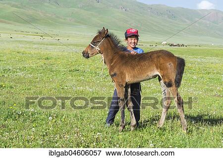 Kyrgyz boy with his foal, Song Kol Lake, Naryn province, Kyrgyzstan, Central Asia, Asia View Large Photo Image Stock Photo - Kyrgyz boy with his foal, Song Kol Lake, Naryn province, Kyrgyzstan, Central Asia, Asia. Fotosearch