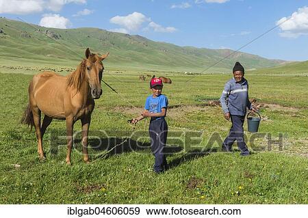 Kyrgyz boy with his horse, Song Kol Lake, Naryn province, Kyrgyzstan, Central Asia, Asia View Large Photo Image Stock Photo - Kyrgyz boy with his horse, Song Kol Lake, Naryn province, Kyrgyzstan, Central Asia, Asia. Fotosearch