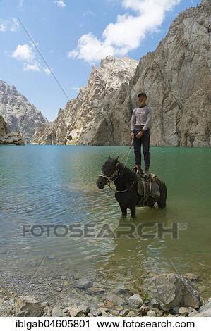 Kyrgyz showing his agility on his horse in Köl-Suu lake, Kurumduk valley, Naryn province, Kyrgyzstan, Asia View Large Photo Image Stock Image - Kyrgyz showing his agility on his horse in Köl-Suu lake, Kurumduk valley, Naryn province, Kyrgyzstan, Asia. Fotosearch
