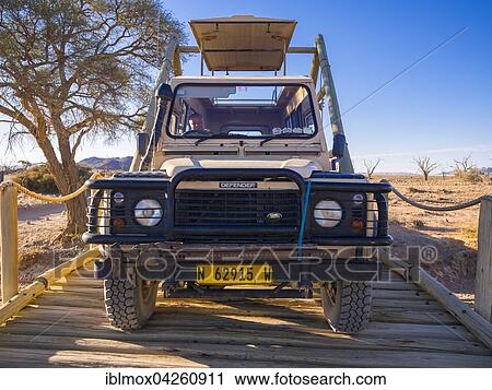 Land Rover crossing a wooden bridge in the Kulala Wilderness Reserve on the edge of the Namib Desert, Hardap Region, Namibia, Africa View Large Photo Image Stock Image - Land Rover crossing a wooden bridge in the Kulala Wilderness Reserve on the edge of the Namib Desert, Hardap Region, Namibia, Africa. Fotosearch
