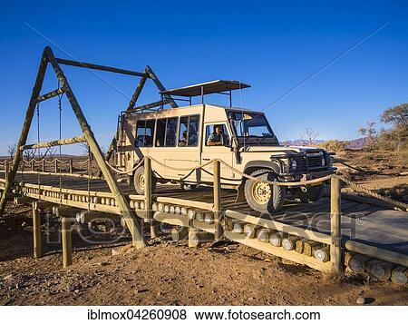 Land Rover crossing a wooden bridge in the Kulala Wilderness Reserve on the edge of the Namib Desert, Hardap Region, Namibia, Africa View Large Photo Image Stock Photo - Land Rover crossing a wooden bridge in the Kulala Wilderness Reserve on the edge of the Namib Desert, Hardap Region, Namibia, Africa. Fotosearch