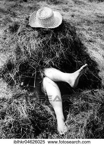 Stock Photography - Legs sticking out of haystacks approx. 1970s, exact place unknown, Czech Republic, Europe. Fotosearch