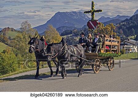 Stock Photo - Leonhardiritt, carriage with cross, in Hinterthiersee, Zahmer Kaiser behind, Tyrol, Austria, Europe. Fotosearch