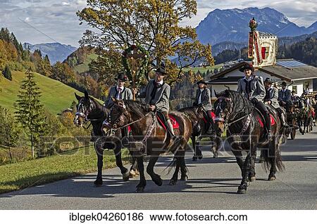 Stock Photograph - Leonhardiritt, horse procession, several riders, Hinterthiersee, Zahmer Kaiser behind, Tyrol, Austria, Europe. Fotosearch
