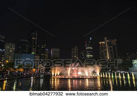 Stock Image - Light show, water fountain, Lake Symphony, city park, skyscrapers, City Centre, Kuala Lumpur, Malaysia, Asia. Fotosearch