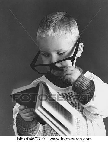 Little boy with big glasses reading a book in full concentration, England, Great Britain View Large Photo Image Stock Image - Little boy with big glasses reading a book in full concentration, England, Great Britain. Fotosearch
