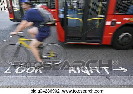 Stock Image - Look Right painted onto the tarmac of a busy road crossing point, Westminster, London, England, United Kingdom, Europe. Fotosearch