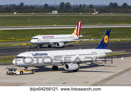 Stock Image - Lufthansa Airbus A321 and German Wings Airbus A320 on taxiways, Dusseldorf International airport, Dusseldorf, North Rhine-Westphalia, Germany, Europe. Fotosearch