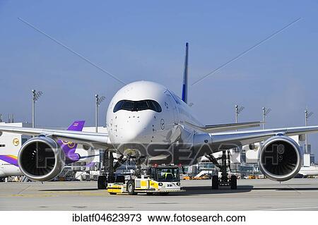 Lufthansa Airbus A350-900, Push Back Truck, Terminal 2, Apron East, Munich Airport, Upper Bavaria, Germany, Europe View Large Photo Image Stock Image - Lufthansa Airbus A350-900, Push Back Truck, Terminal 2, Apron East, Munich Airport, Upper Bavaria, Germany, Europe. Fotosearch