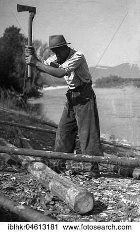 Stock Image - Man chopped wood with an axe, ca. 1945 to 1955, near Freiburg, Germany, Europe. Fotosearch