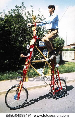 Stock Image - Man on a curious bicycle, England, Great Britain. Fotosearch