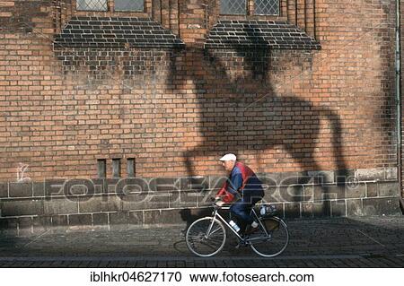 Man on bicycle next to shadow of a horse with rider, Berlin, Germany, Europe View Large Photo Image Stock Image - Man on bicycle next to shadow of a horse with rider, Berlin, Germany, Europe. Fotosearch