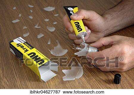 Man repair bulb with glue, Germany, Europe View Large Photo Image Stock Photo - Man repair bulb with glue, Germany, Europe. Fotosearch