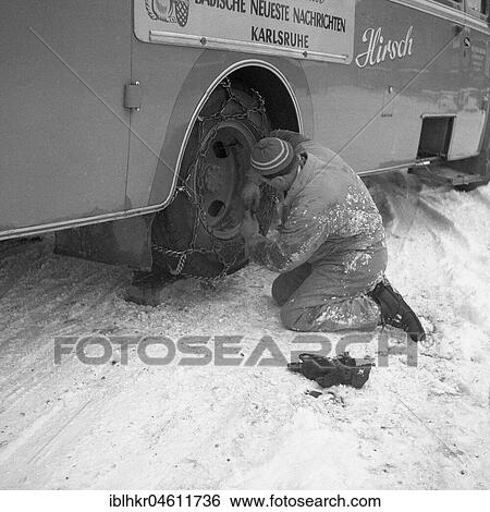Man repairing the tyre of a bus around 1950 in winter, near Freiburg, Germany, Europe View Large Photo Image Stock Photograph - Man repairing the tyre of a bus around 1950 in winter, near Freiburg, Germany, Europe. Fotosearch