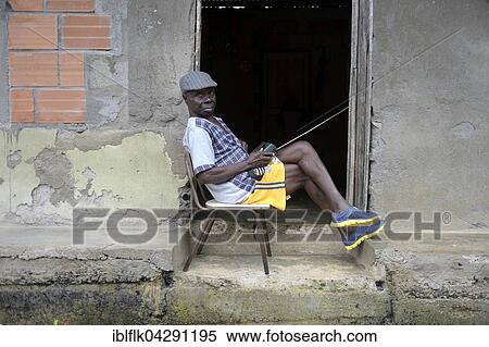 Man sitting with radio at the door, afro-columbian village of El Salto on the River Rio Andagueda, Choco Department, Colombia, South America View Large Photo Image Stock Photography - Man sitting with radio at the door, afro-columbian village of El Salto on the River Rio Andagueda, Choco Department, Colombia, South America. Fotosearch