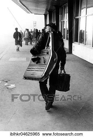 Stock Photography - Man with car door ca. 1970s, exact place unknown, Czech Republic, Europe. Fotosearch