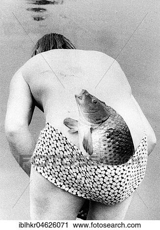 Man with fish in swimsuit ca. 1970s, exact place unknown, Czech Republic, Europe View Large Photo Image Stock Image - Man with fish in swimsuit ca. 1970s, exact place unknown, Czech Republic, Europe. Fotosearch