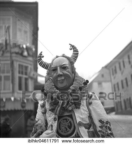 Stock Image - Man with mask on a parade, carnival, around 1950, around Freiburg, Germany, Europe. Fotosearch