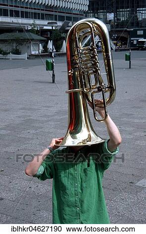 Stock Image - Man with tuba on his head, Berlin, Germany, Europe. Fotosearch