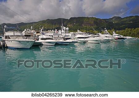Marina, harbor with luxury yachts, artificial island Eden Island in front of Mahe, Seychelles, Africa View Large Photo Image Stock Photo - Marina, harbor with luxury yachts, artificial island Eden Island in front of Mahe, Seychelles, Africa. Fotosearch