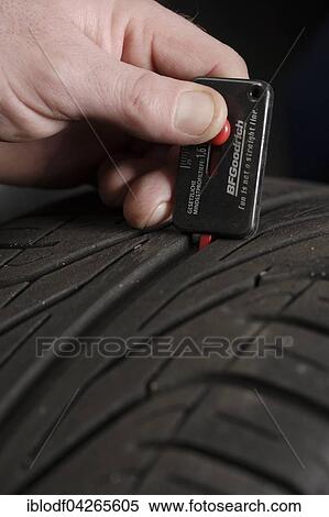 Measuring a car tire's tread depth, summer tires, winter tires, Germany, Europe View Large Photo Image Stock Photography - Measuring a car tire's tread depth, summer tires, winter tires, Germany, Europe. Fotosearch