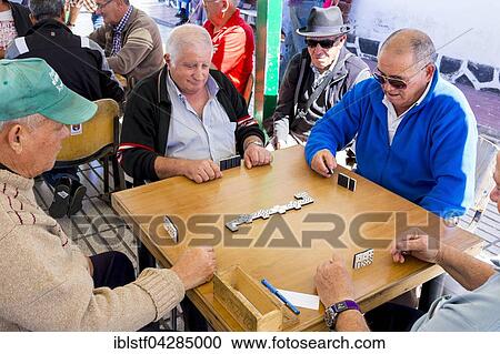 Stock Image - Men playing dominoes, Arrecife, Lanzarote, Canary Islands, Spain, Europe. Fotosearch