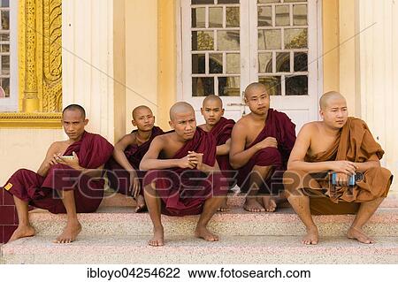Stock Image - Monks sitting and resting, Mahamuni Paya, Chanmyathazi, Mandalay, Myanmar, Asia. Fotosearch