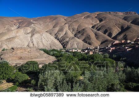 Stock Photo - Mountains, eroded landscape with river oasis and small village in the upper Dades valley, Oued Dades near Msemrir, High Atlas, South Morocco, Morocco, Africa. Fotosearch