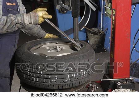 Mounting a tire on a wheel in the workshop, summer tires, winter tires, Germany, Europe View Large Photo Image Stock Image - Mounting a tire on a wheel in the workshop, summer tires, winter tires, Germany, Europe. Fotosearch