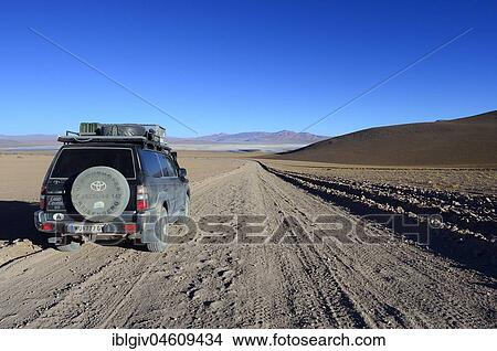 Picture - Off-road vehicle on the way along the lagoon route, Reserva Nacional de Fauna Andina Eduardo Abaroa, Sur Lípez, Potosí, Bolivia, South America. Fotosearch